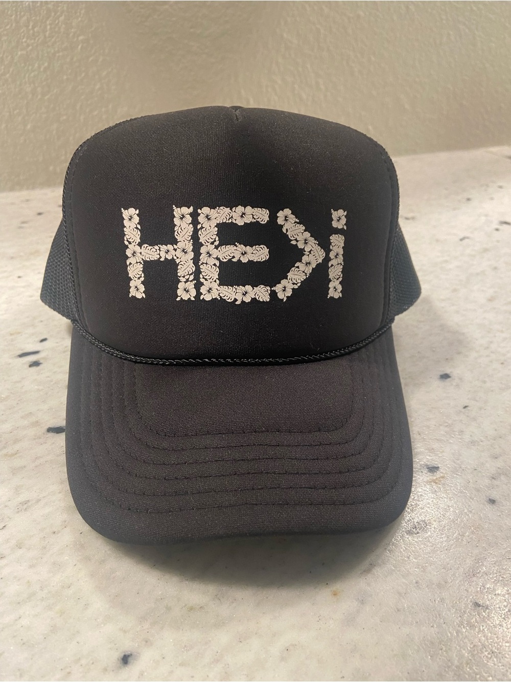 Flora Foam HE>I Logo Trucker Hat in black